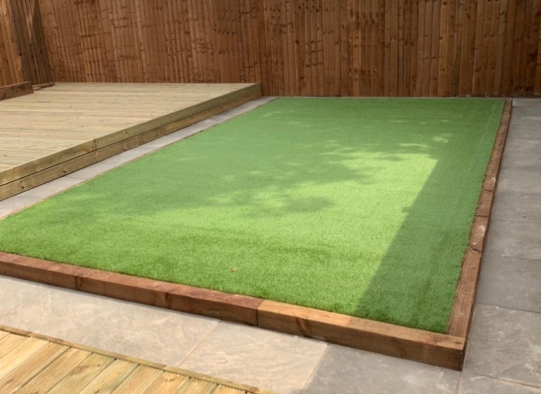 Timber deck, sleeper-edged lawn and fence panels